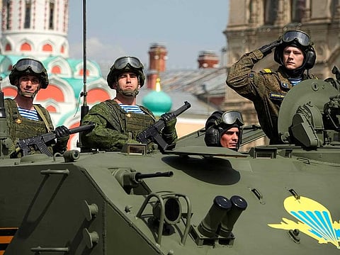 Russian Army soldiers stand in a military vehicle rolling during a dress rehearsal for the Victory Day military parade in Moscow, Russia, Saturday, May 7, 2022. 