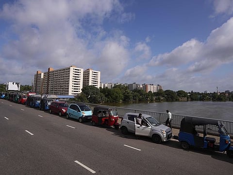 Motorists queue up outside a fuel station to buy gasoline in Colombo, Sri Lanka, Friday, May 20, 2022.