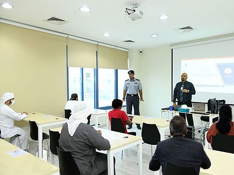Motorists attending a course on traffic laws in order to recover their driving licence.