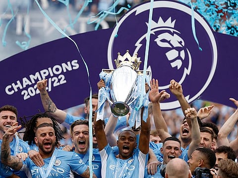 Manchester City's Fernandinho lifts the trophy with teammates after winning the Premier League. 