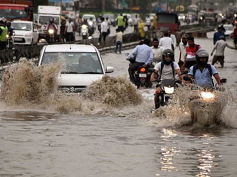 Vehicles commute through waterlogged Delhi-Gurugram Expressway and service road after heavy rain, in Gurugram on Monday.