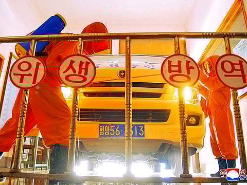 Employees of the Central Post Office disinfect a vehicle amid COVID-19 spread prevention efforts in Pyongyang, North Korea in this photo dated May 22, 2022 and released May 23, 2022 by the country's Korean Central News Agency.