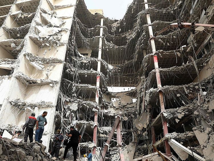 Iranians gather at the site where a ten-storey building collapsed as rescue operations continue in the southwestern city of Abadan on May 24, 2022. 