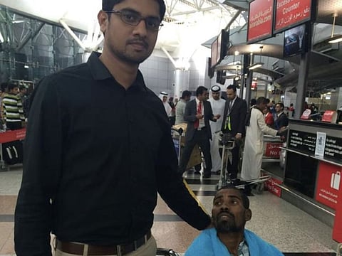 Deepak Thomas with one of the many needy residents whom he reached out to as part of his volunteering work in the UAE.