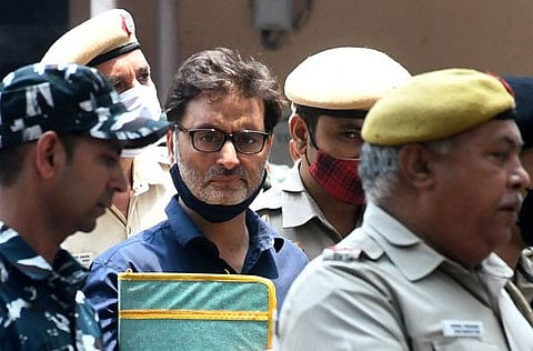 Yasin Malik, chairman of Jammu Kashmir Liberation Front (JKLF), is escorted by Indian police officers at a court premises in New Delhi, India, May 25, 2022.