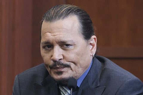 Actor Johnny Depp reacts as he testifies in the courtroom during his defamation trial against his ex-wife Amber Heard, at the Fairfax County Circuit Courthouse in Fairfax, Virginia, U.S., May 25, 2022.