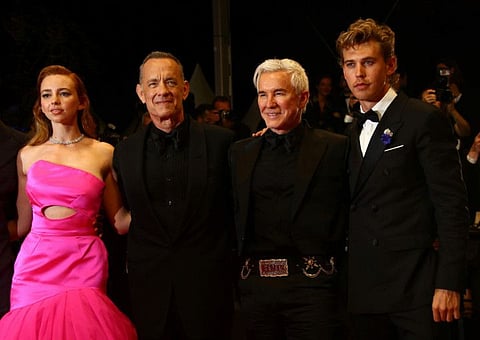 Natasha Bassett, Tom Hanks, director Baz Luhrmann, and Austin Butler pose for photographers upon departure from the premiere of the film 'Elvis' at the 75th international film festival, Cannes, southern France, Wednesday, May 25, 2022.