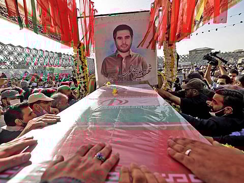 Mourners gather around the coffin of Iran's Revolutionary Guards colonel Sayyad Khodai during a funeral procession at Imam Hussein square in the capital Tehran, on May 24, 2022.  