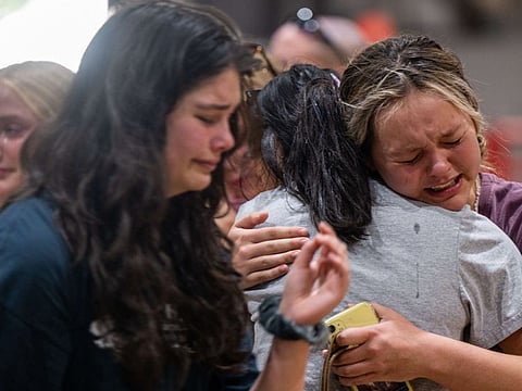 Community members mourn together at a vigil for the 21 victims in the mass shooting at Rob Elementary School on May 25, 2022 in Uvalde, Texas. 