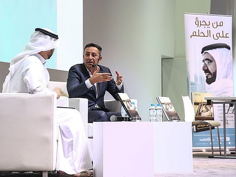 Raed Barqawi (R) interviewed by news presenter Faisal bin Huraiz after the book launch 