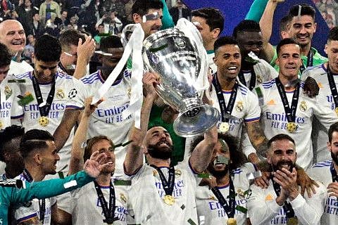 Real Madrid's French forward Karim Benzema (centre) and his teammates celebrate with the trophy after the UEFA Champions League final against Liverpool at the Stade de France in Saint-Denis, north of Paris. Real Madrid won 0-1.