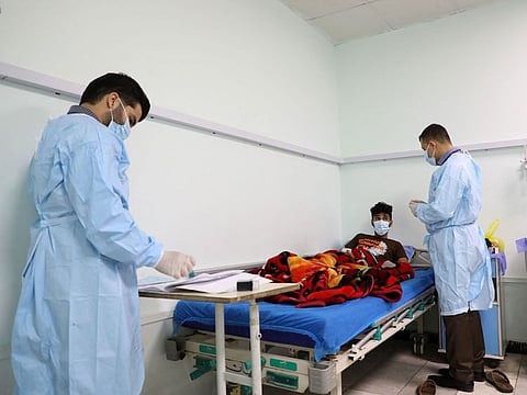 Doctors at a hospital in Iraq's southern Dhi Qar province examine a patient in a March 25, 2022 photo. Cholera is an acute diarrhoeal disease that is treatable with antibiotics and hydration but can kill within hours without medical attention.