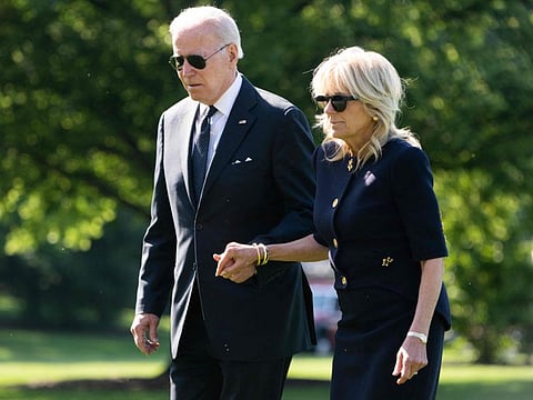 US President Joe Biden and US First Lady Jill Biden walk on the South Lawn of the White House in Washington, DC.