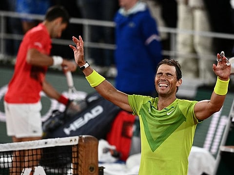 Spain's Rafael Nadal (R) reacts after winning against Serbia's Novak Djokovic (L) at the end of their men's singles match on day ten of the Roland-Garros Open tennis tournament at the Court Philippe-Chatrier in Paris early June 1, 2022. 