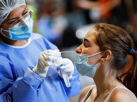 File photo: A healthcare worker takes a swab sample from a woman to be tested for the COVID-19, at La Rural, in Buenos Aires, Argentina.