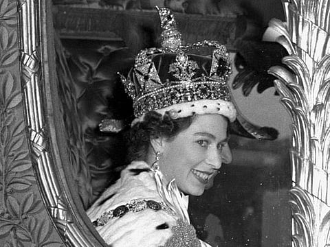 Queen Elizabeth II gives a broad smile to the crowd from her carriage as she leaves Westminster Abbey, London, after her Coronation in 1953.