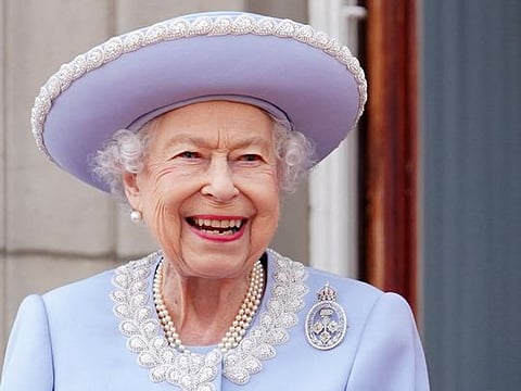 Britain's Queen Elizabeth II stands on the Balcony of Buckingham Palace as the troops march past during the Queen's Birthday Parade, the Trooping the Colour, as part of Queen Elizabeth II's platinum jubilee celebrations, in London on June 2, 2022. 