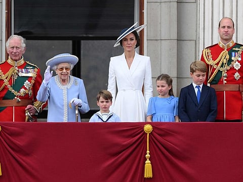 Britain's Queen Elizabeth II with (from left) Britain's Prince Charles, Prince of Wales, Britain's Prince Louis of Cambridge, Britain's Catherine, Duchess of Cambridge, Britain's Princess Charlotte of Cambridge , Britain's Prince George of Cambridge, Britain's Prince William, Duke of Cambridge, to watch a special flypast from Buckingham Palace balcony following the Queen's Birthday Parade, the Trooping the Colour, as part of Queen Elizabeth II's platinum jubilee celebrations, in London on June 2, 2022.  