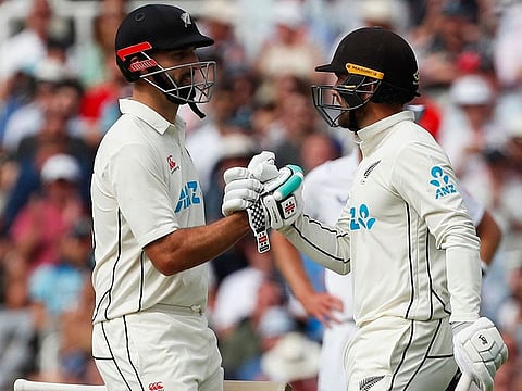 New Zealand keeper Tom Blundell (right) is congratulated by Daryl Mitchell after scoring a half-century during their resilient unbroken partnership on Friday.