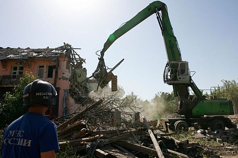 Russian Emergencies personnel clear the rubble of a building in the city of Mariupol on June 2, 2022, amid the ongoing Russian military action in Ukraine.