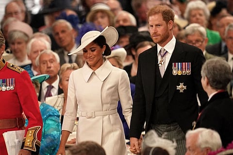 Britain's Prince Harry, Duke of Sussex (right) and Meghan, Duchess of Sussex, attend the National Service of Thanksgiving for The Queen's reign at Saint Paul's Cathedral in London on June 3, 2022.