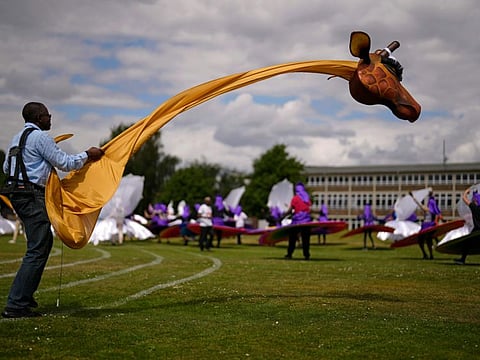A member of the Mahogany carnival group with a giraffe costume takes part in a rehearsal for their upcoming performance at the Platinum Jubilee Pageant, at Queens Park Community School, in north London.