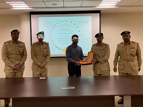 Tariq Mahmood Khalid Mahmood (centre) being honoured at Al Barsha Police Station in Dubai, where he had handed over the money