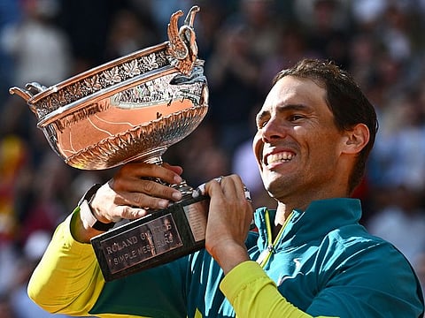 Rafael Nadal poses with The Musketeers' Cup as he celebrates after beating Casper Ruud during their men's singles final match on day fifteen of the Roland-Garros Open tennis tournament at the Court Philippe-Chatrier in Paris.
