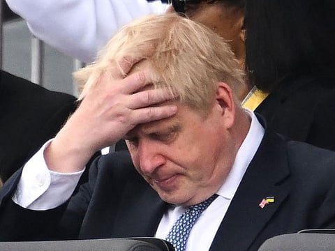 Britain's Prime Minister Boris Johnson reacts during the Platinum Pageant in London on June 5, 2022 as part of Queen Elizabeth II's platinum jubilee celebrations.