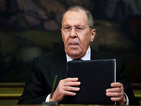 Russian Foreign Minister Sergey Lavrov holds documents during a press conference in Moscow, Russia, Friday, April 8, 2022.