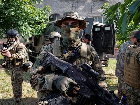 Members of the foreign volunteers unit which fights in the Ukrainian army look on, as Russia's attack on Ukraine continues, in Sievierodonetsk, Luhansk region.