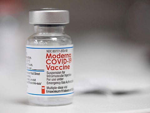 A vial of the Moderna COVID-19 vaccine is displayed on a counter at a pharmacy in Portland.
