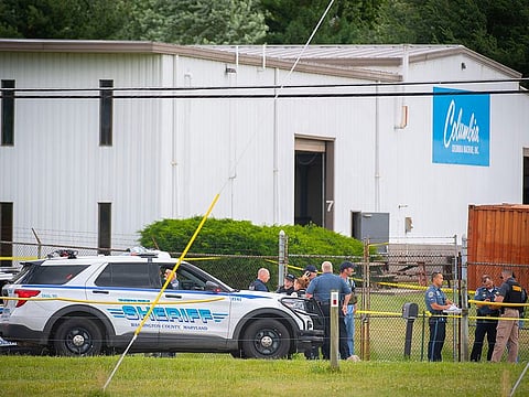 Law enforcement officials stand near the scene of a shooting at Columbia Machine, Inc., in Smithsburg, Md., Thursday, Jan. 9, 2022.