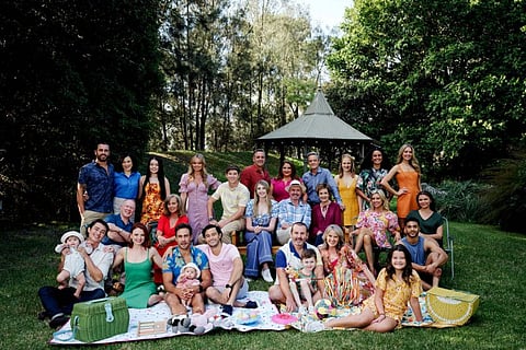 This handout photograph taken on March 3, 2022 and released by production company Fremantle on June 9, 2022, shows the cast of the Australian soap opera "Neighbours" posing for a picture in Melbourne.