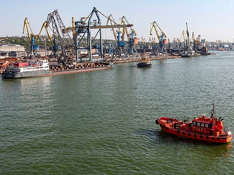 A Russian vessel, top left, prepares to depart from the Mariupol Sea Port in Mariupol, in territory under the government of the Donetsk People's Republic, eastern Ukraine, Tuesday, May 31, 2022. It marked the first time that a commercial ship used the port of Mariupol since the start of the Russian military action in Ukraine.