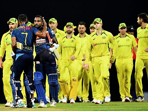 Sri Lanka's captain Dasun Shanaka (second left) celebrates with with teammate Chamika Karunaratne after winning the third and final Twenty20 international cricket match against Australia at the Pallekele International Cricket Stadium in Kandy.