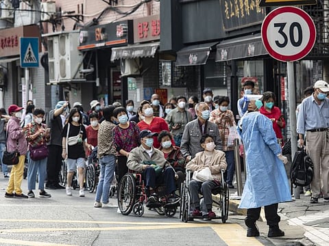 Residents line up for a COVID-19 testing in the Hongkou District of Shanghai, on June 11, 2022.  