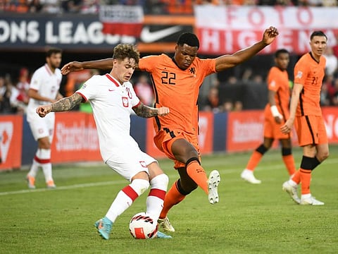 Netherlands' Denzel Dumfries in action with Poland's Nicola Zalewski.