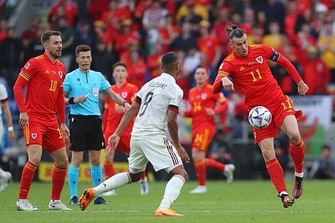 Wales' midfielder Gareth Bale (right) controls the ball during the UEFA Nations League - League A Group 4 football match against Belgium at the Cardiff City Stadium in Cardiff.