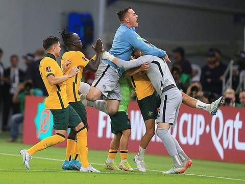 Australian players celebrate after winning in a penalty shoot-out during the World Cup 2022 qualifying play-off soccer match between Australia and Peru in Al Rayyan, Qatar, Monday, June 13, 2022.
