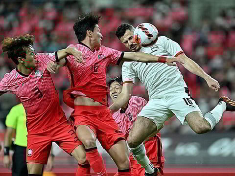 Egypt's Mahmoud Hamdy (right) fights for the ball with South Korea's Hwang Ui-jo (centre) and Kim Jin-su during a friendly in Seoul.