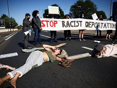 Activists block a road leading away from the Colnbrook Immigration Removal Centre as they protest against the British Governments plans to deport asylum seekers to Rwanda, near Heathrow airport in London, June 14, 2022.
