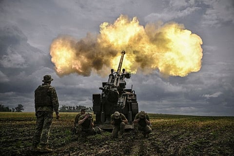 Ukrainian servicemen fire with a French self-propelled 155 mm/52-calibre gun Caesar towards Russian positions at a front line in the eastern Ukrainian region of Donbas on June 15, 2022. 