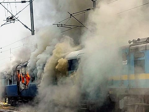 Smoke billows out after youngsters set fire to a train in protest against the 'Agnipath' scheme, in Chhapra on Thursday. 