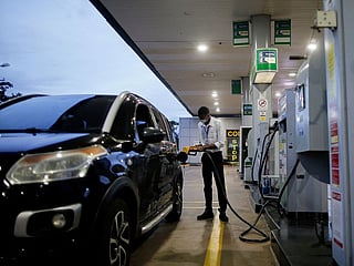 A worker uses a petrol pump at a Brazilian oil company Petrobras gas station in Brasilia, Brazil March 7, 2022. 