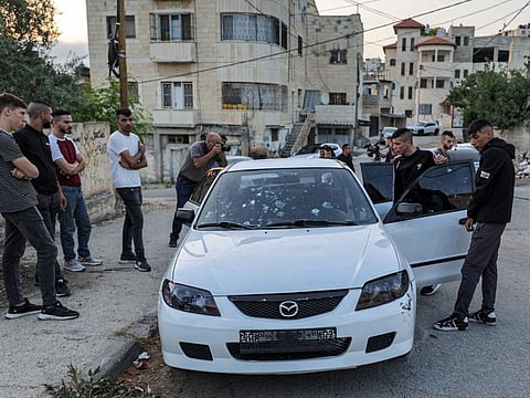 Locals inspect the bullet-riddled vehicle where three Palestinians were killed in an operation by Israeli forces in Jenin.