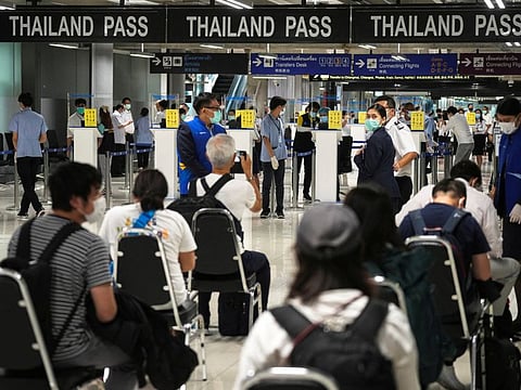 Foreign tourists prepare their documents at the new entry lanes at Suvarnabhumi Airport during the first day of the country's reopening campaign, part of the government's plan to jump start the pandemic-hit tourism sector in Bangkok, Thailand November 1, 2021.