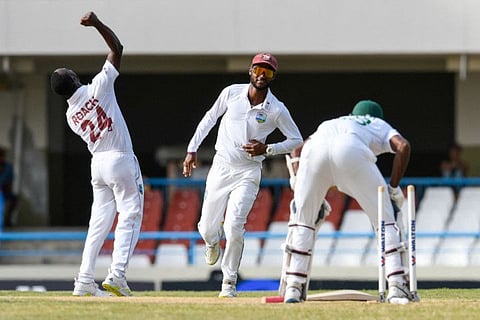 Kemar Roach (left) and Kraigg Brathwaite (centre), of West Indies, celebrate the dismissal of Ebadot Hossain Chowdhury, of Bangladesh, during the Test match at Vivian Richards Cricket Stadium in North Sound, Antigua and Barbuda.