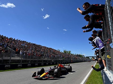 Race winner Max Verstappen of the Netherlands passes his team celebrating on the pitwall during the F1 Grand Prix of Canada at Circuit Gilles Villeneuve in Montreal, Quebec.