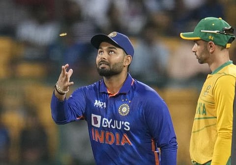 India's captain Rishabh Pant with South Africa's Keshav Maharaj at the start of their fifth Twenty20 cricket match in Bengaluru, India.